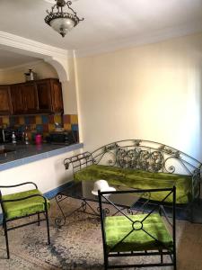 a room with a table and chairs in a kitchen at Moana Guest House in Tamraght Ouzdar