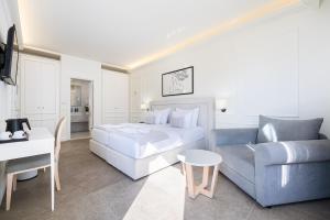 a hotel room with a bed and a couch at Hotel Eden in Budva
