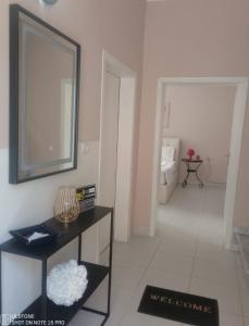 a living room with a mirror and a bathroom at Andrea House in Berat
