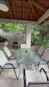 a glass table and chairs on a patio at Stone Villa in Bečići