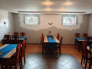 a dining room with blue tables and chairs at Hotel Margo in Cedynia