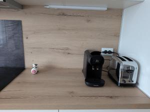 a kitchen counter with a coffee maker and a toaster at Gîte LM in Bourbonne-les-Bains