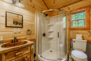 a bathroom with a shower and a sink and a toilet at Bonnie & Clyde in Cate crossroad +4 photos
