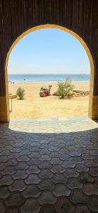an archway with a view of the beach at Safarova Tours in Fayoum +12 photos