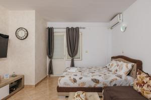 a living room with a bed and a couch at Mir & More in Budva