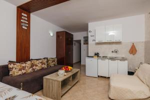 a living room with a couch and a kitchen at Mir & More in Budva