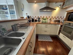 a kitchen with a sink and a stove at La croisière in Capbreton