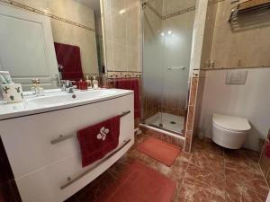 a bathroom with a sink and a shower and a toilet at La croisière in Capbreton +33 photos