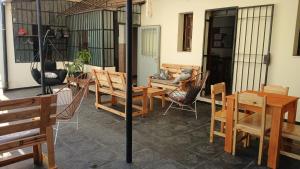 a patio with chairs and tables and a table and chairs at MillaUno Hostel in Córdoba
