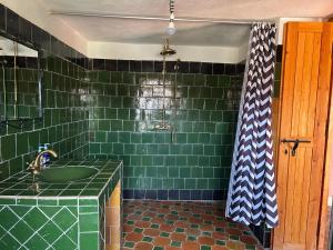 a green tiled bathroom with a sink and a shower at Kasbah Petit Nomade in Tinerhir +73 photos