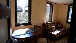 a living room with a table and a couch at Apartmán Daniela in Bansko