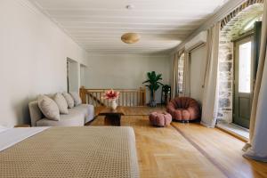 a living room with a bed and a couch at Mesta Grand Residence in Chios