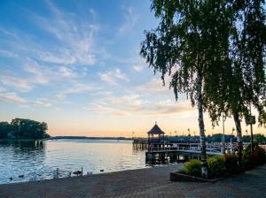 a dock on the water with a pier at Domek Ostróda in Ostróda