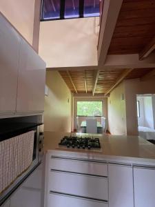 a kitchen with a stove top oven next to a window at Refugio de Guacamayas in Mérida +20 photos