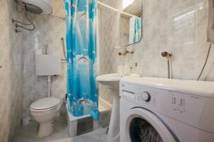 a bathroom with a toilet and a washing machine in it at Mir & More in Budva +69 photos