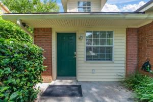 a green door on a house with a brick at Mid-Century Studio Kitchenette Wi-Fi in Jacksonville