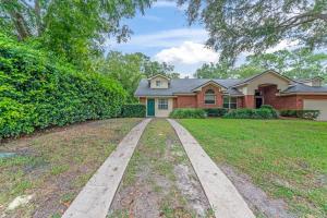 a house with a driveway in front of it at Mid-Century Studio Kitchenette Wi-Fi in Jacksonville