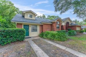 a red brick house with a blue door at Mid-Century Studio Kitchenette Wi-Fi in Jacksonville