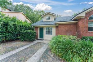 a brick house with a green door at Mid-Century Studio Kitchenette Wi-Fi in Jacksonville +7 photos