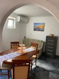 a living room with a table and a couch at Stone Villa in Bečići +29 photos