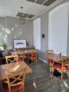 a dining room with wooden tables and chairs at Pension Haus Weierts in Norderney