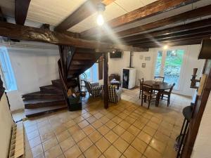 a living room with a staircase and a table at Le Gîte Chez Mémé in Lavelanet