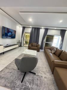 a living room with a couch and a table at Family House Assinie in Assinie