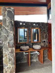 a stone bathroom with two sinks and two mirrors at Finca Mirador De Gualaca in Gualaca +38 photos