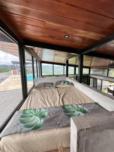 a bed in the middle of a house at Finca Mirador De Gualaca in Gualaca