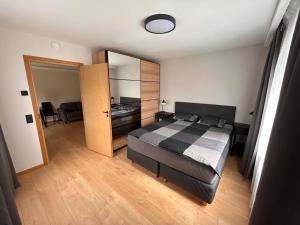 a bedroom with a bed and a large mirror at Roosi Kodumajutus in Pärnu