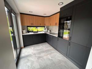a kitchen with black cabinets and a counter top at Roosi Kodumajutus in Pärnu