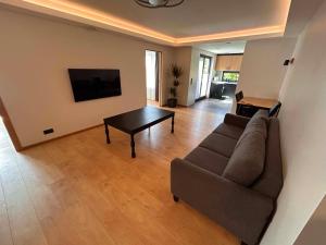 a living room with a couch and a table at Roosi Kodumajutus in Pärnu