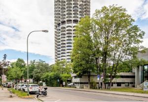 a tall building with a scooter parked on the side of a street at Global Bnb - Loft 28 Green in Augsburg