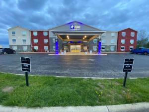 a hotel with two signs in a parking lot at Holiday Inn Express Bluffton by IHG in Bluffton