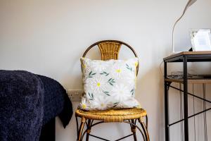 a pillow on a chair next to a bed at The Hide at St Andrews in Fife