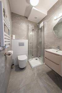 a bathroom with a shower and a toilet and a sink at Pokoje ABC Centrum in Ustka +43 photos