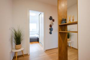 a hallway with a room with a bed and a table at Apartment 98A7 in Povljana