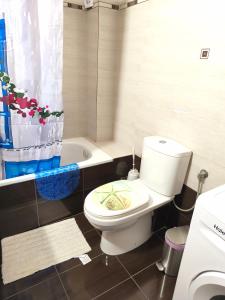 a bathroom with a toilet and a bath tub at Ester's Sea Side apartment in Neoi Epivates +24 photos