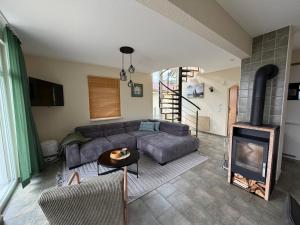 a living room with a couch and a fireplace at Ferienhaus Seestern direkt am Plauer See in Plau am See
