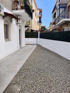 a walkway in front of a white building at Naxos Blu Appartament in Giardini Naxos