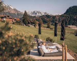 two people are laying on an inflatable at Anton & Cilli Hideaway Lodges in Obermaiselstein