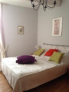 a bedroom with a white bedspread and white pillows at l'Arche des Chapeliers in Foix