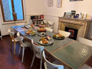 a dining room with a table with food on it at QG Marseille in Marseille