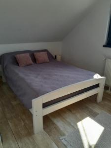 a bedroom with a large bed with purple sheets at Bara Apartment and Studio in Gheorgheni