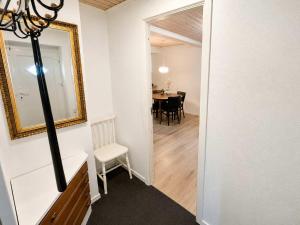 a room with a mirror and a table with a chair at Klaksvik Mountain View Stay in Klaksvík