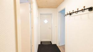 a hallway with a mirror and a black rug at Klaksvik Mountain View Stay in Klaksvík