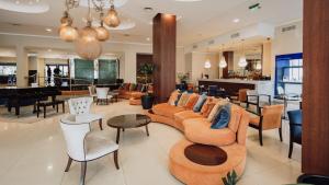 a lobby with couches and tables and a piano at Turismo Hotel Casino in Corrientes