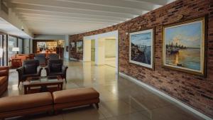 a lobby with chairs and a brick wall at Turismo Hotel Casino in Corrientes