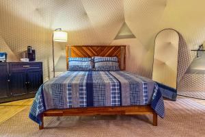 a bedroom with a bed with a wooden head board at Luxury Catskill Mountains Dome Retreat in Gilboa
