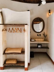 a room with shelves and a mirror on the wall at Hotel Boutique Cenote Secreto Maya in Valladolid